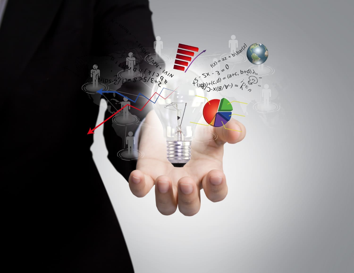 A businessman holds a light bulb with various business icons, symbolizing creativity and innovation in the business world.